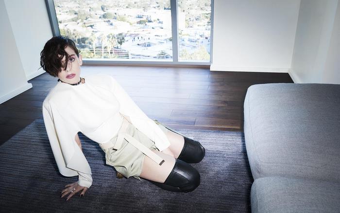 Alison Brie sitting on floor in modern room