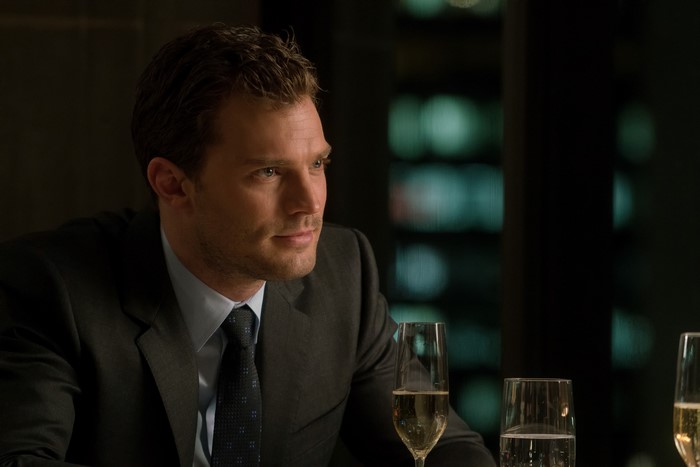 Jamie Dornan in a suit with champagne