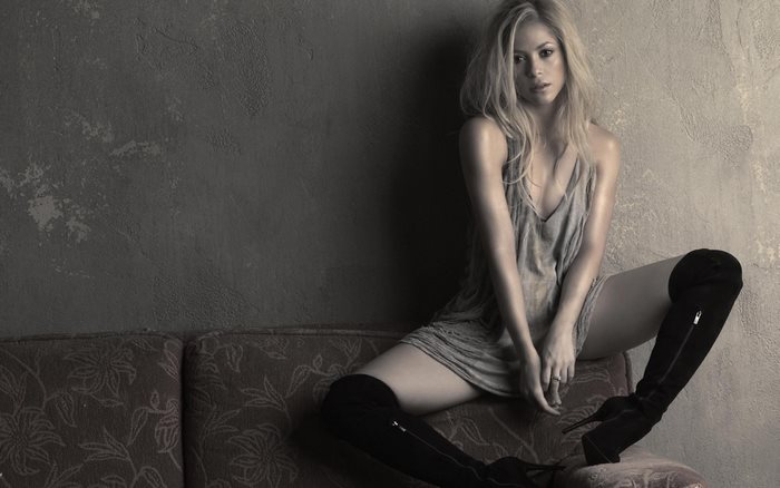 Shakira sitting on a couch