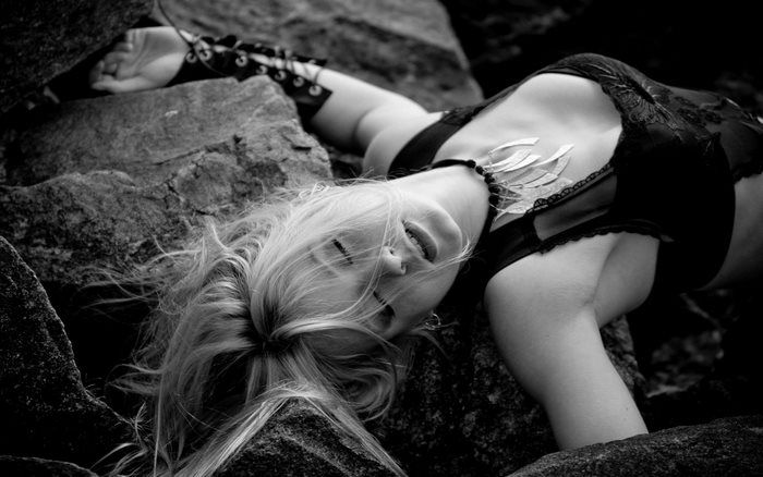 Woman lying on rocks