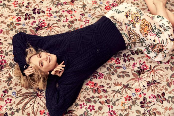 Lili Reinhart lying on a floral rug
