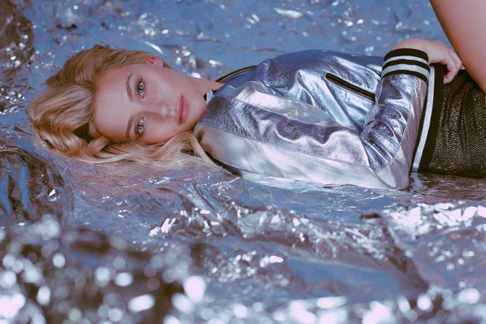 Lili Reinhart lying on metallic material
