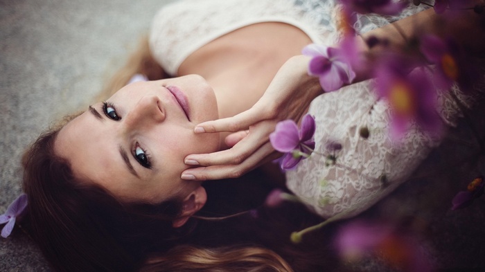 Woman lying down with purple flowers