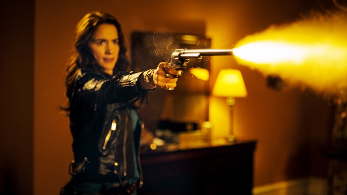 Melanie Scrofano firing a gun