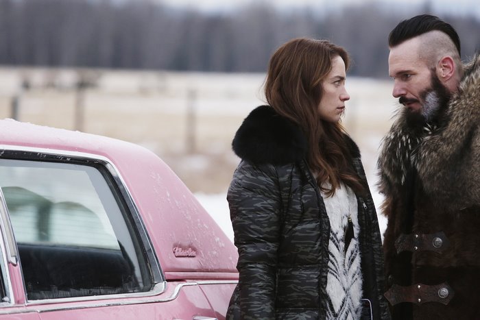 Melanie Scrofano and man in fur coat
