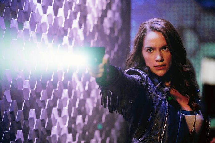 Melanie Scrofano holding a futuristic gun