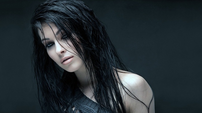 Woman with wet black hair and dark clothing