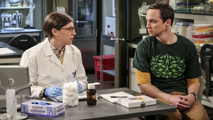 Sheldon and Amy in a laboratory
