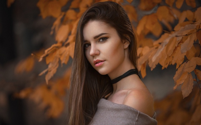 Woman with long brown hair and choker