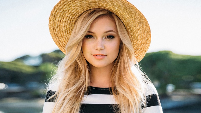 Olivia Holt wearing a straw hat
