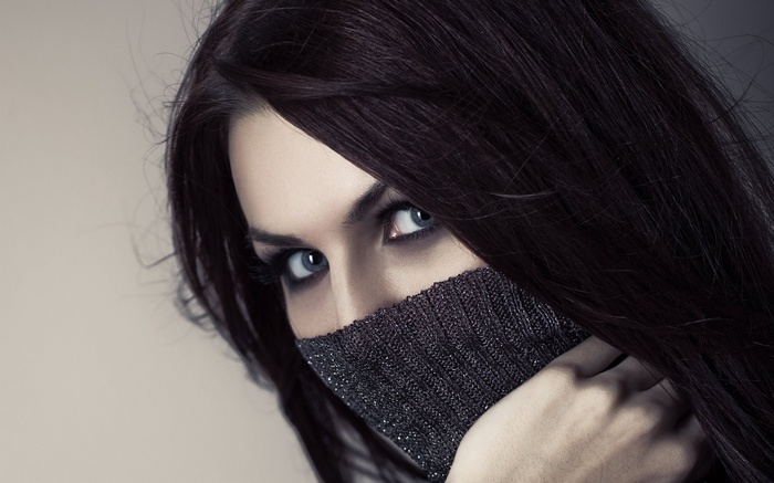 Woman with dark hair wearing a turtleneck