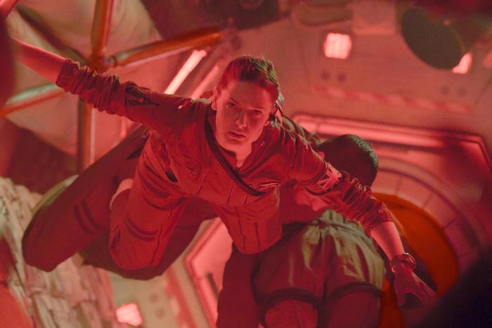 Rebecca Ferguson in a red spacesuit