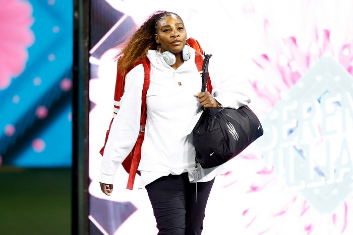 Serena Williams with backpack and duffel bag