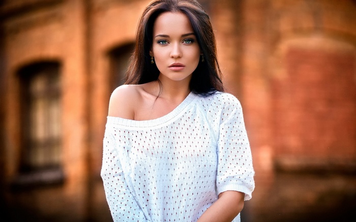 Woman in white off-the-shoulder sweater