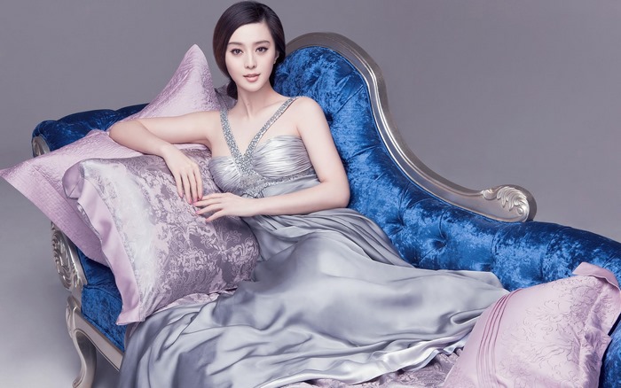 Fan Bingbing on a blue chaise lounge