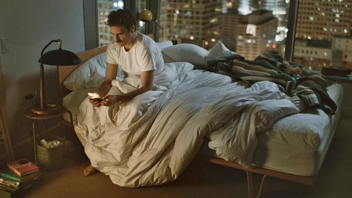 Joaquin Phoenix in a bedroom at night