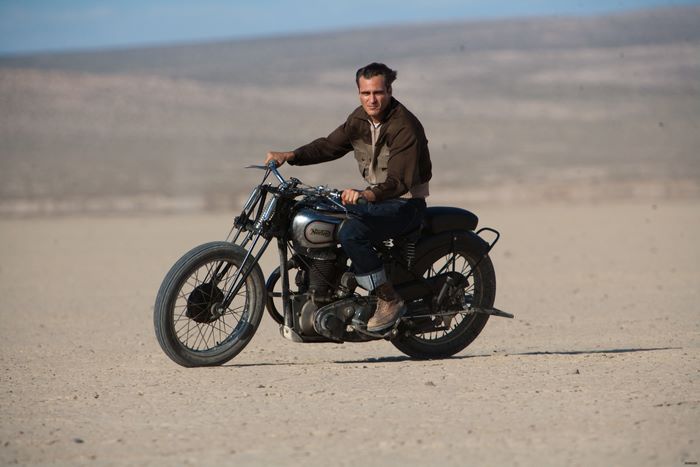 Joaquin Phoenix riding a motorcycle in a desert