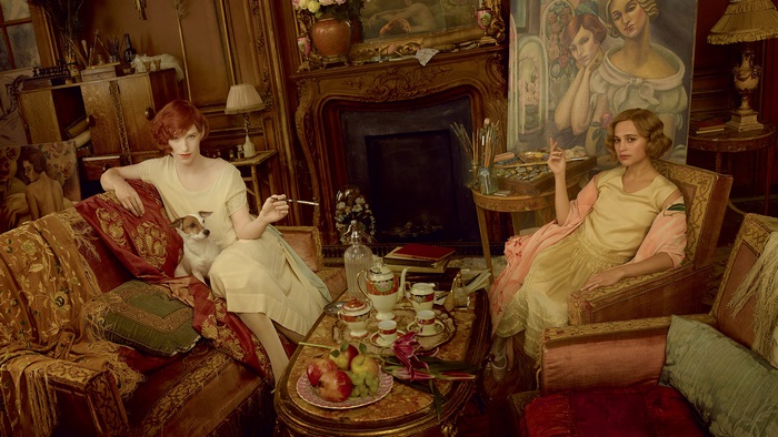 Two women and a dog in a lavish room