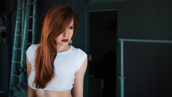 Woman with red hair wearing a white crop top