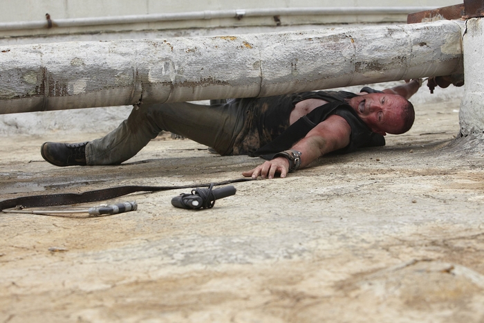 Michael Rooker under a pipe