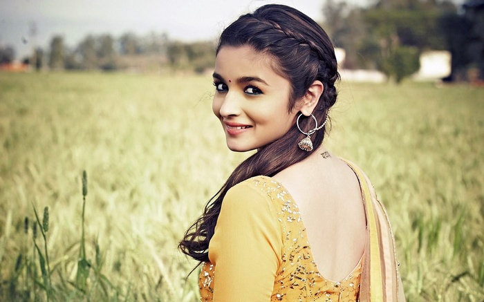 Alia Bhatt in a yellow outfit in a field