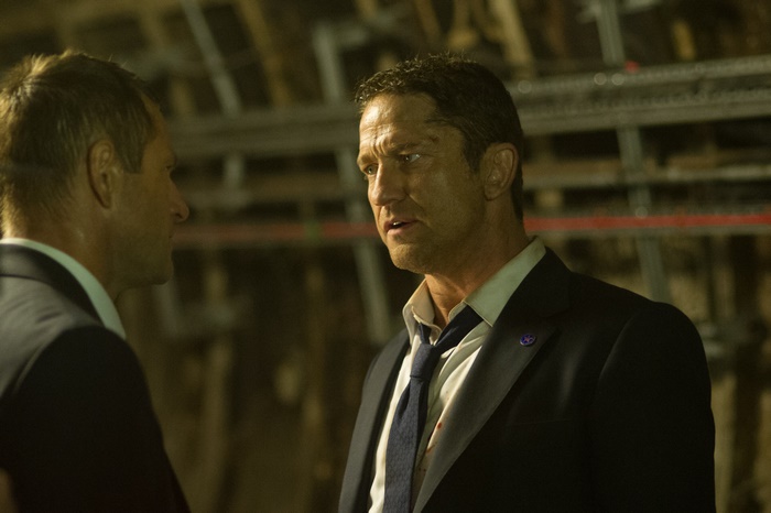 Aaron Eckhart in a dark suit