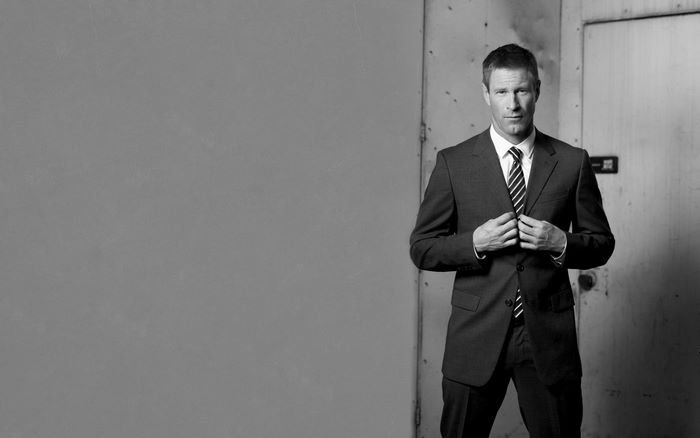 Aaron Eckhart in a suit