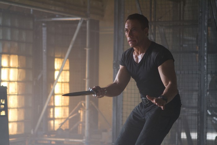 Jean-Claude Van Damme holding a knife
