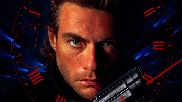 Jean-Claude Van Damme with a gun and clock