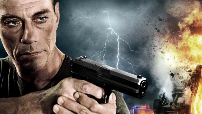 Jean-Claude Van Damme holding a gun