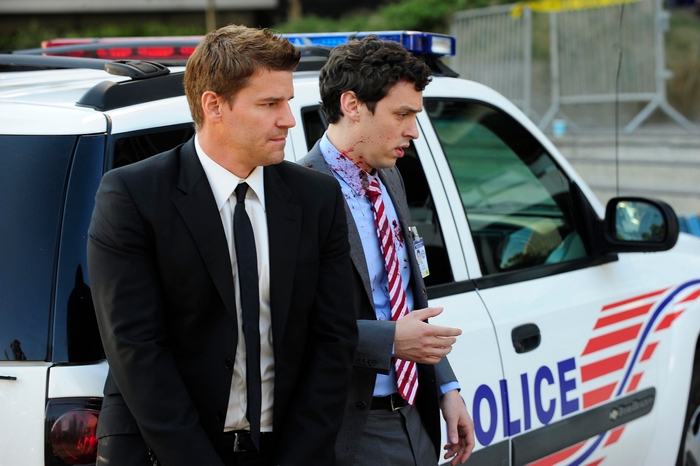 John Francis Daley and man in suit next to police car
