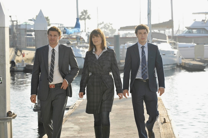 John Francis Daley and two others on a dock
