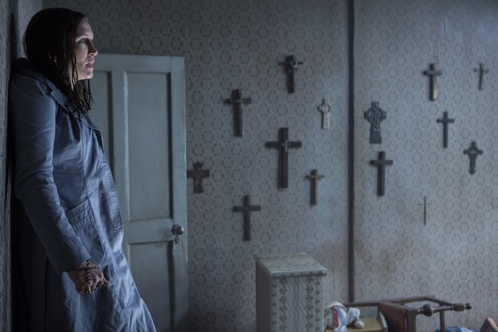Vera Farmiga in a room with crosses