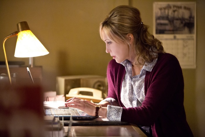Vera Farmiga working on a laptop
