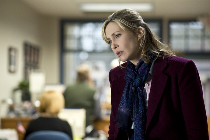 Vera Farmiga in an office setting