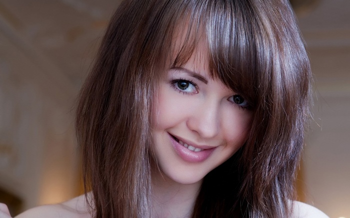 Young woman with brown hair smiling