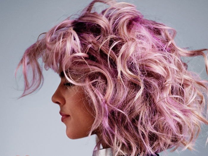 Emily Bett Rickards with pink and blonde curly hair