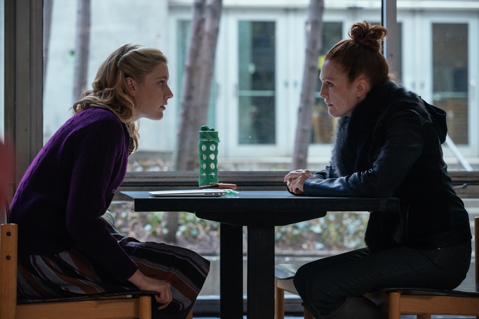 Greta Gerwig and woman sitting at table