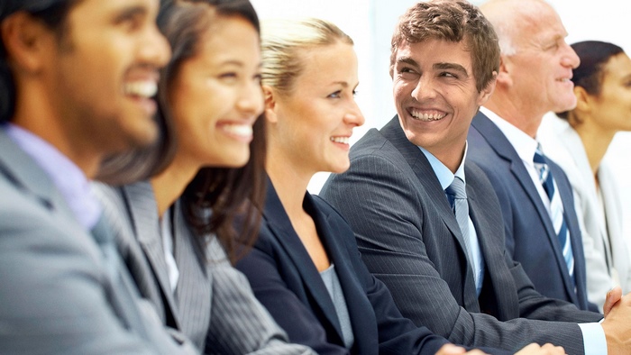 Group of business people in suits smiling
