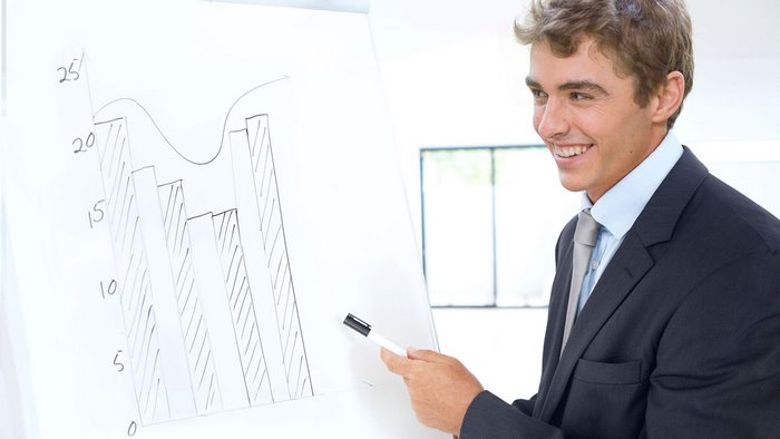 Man in suit presenting a bar chart