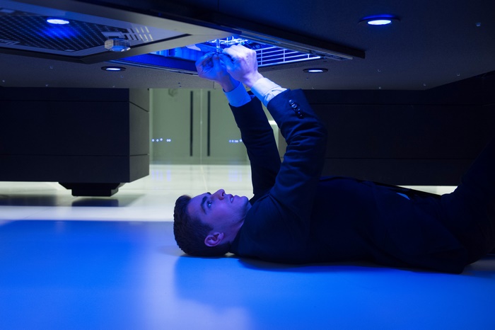Dave Franco working on a futuristic console
