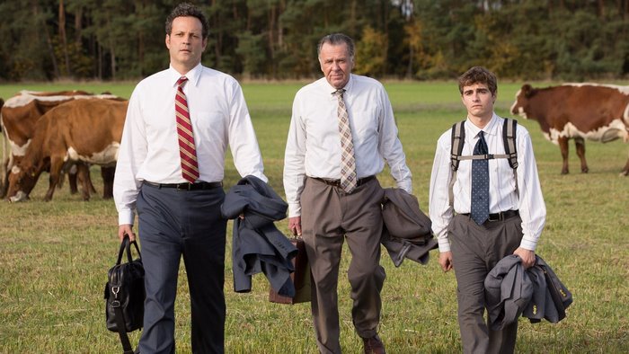 Dave Franco and two men in a field with cows