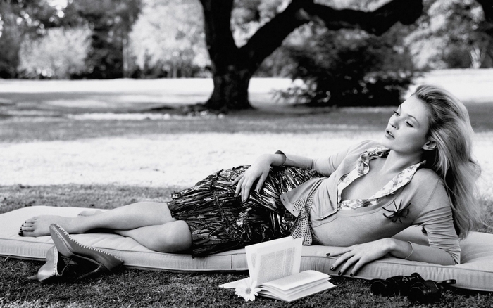 Kate Moss lying on a mattress outdoors