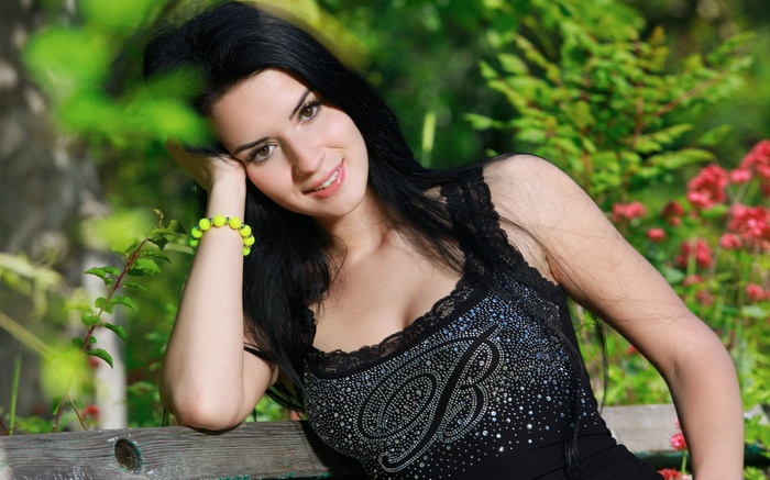 Woman with black hair wearing a black top