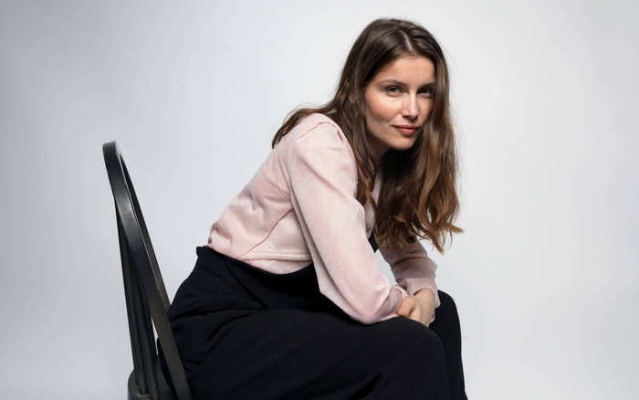 Laetitia Casta sitting on a chair