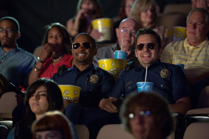 Two police officers watching a movie