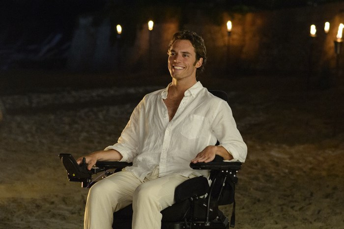 Sam Claflin in a wheelchair on a beach at night