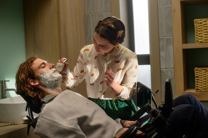 Sam Claflin being shaved by a woman