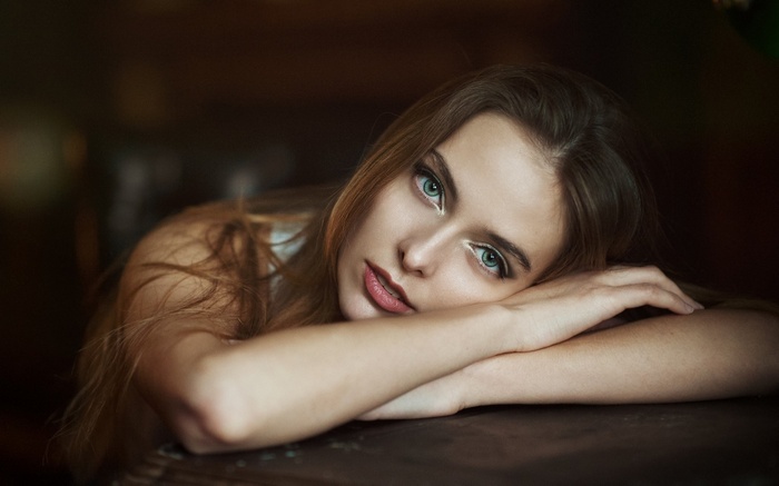 Woman resting her head on her arms