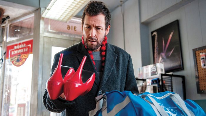 Adam Sandler holding red high heels
